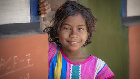 Smiling Young Girl in Colorful Dress